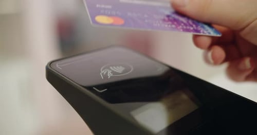 Person Hand Paying with Credit Card at Pos Terminal with NFC