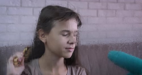 Girl Brushing Hair with Brush and Hair Dryer