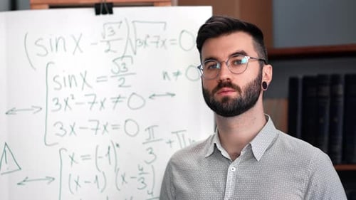 Adult Man Explains Math Equations on Whiteboard