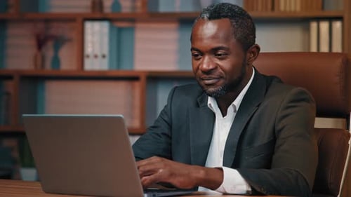 Successful Businessman Working in Office Typing on Laptop Checking Email Happy Pleased African