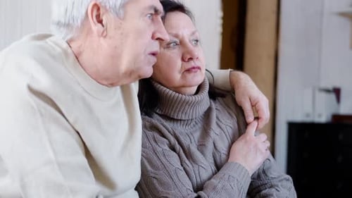 Senior Couple Embracing Inside Home