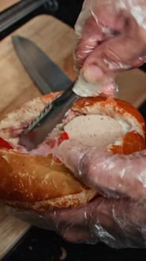 Hands Prepare Delicious Sandwich with Meat and Vegetables