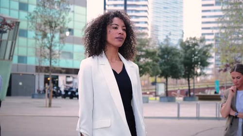 Confident Businesswoman Walking in City Center