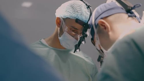 Team of Professional Surgeons Perform Heart Transplant Operation in Medical Operating Room Team