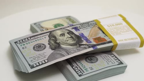 Stack of Bank Bundles with US Dollars on a White Background Closeup Shot of New Freshly Printed