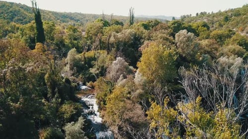 aerial view of drone flying above beautiful tropical waterfall