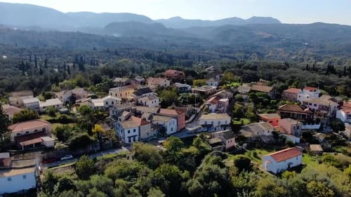 Close Aerial Drone Shot of Traditional Mediterranean Village Houses with Tiled Roofs Among Olive Gro