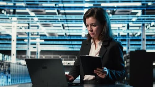 Data Center Specialist Crosschecking Settings Between Laptop and Tablet