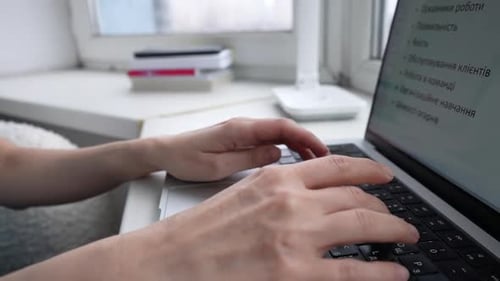 Typing on Laptop Keyboard at Bright Desk