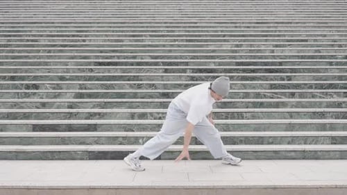 Breakdancer Performing Various Moves on Urban Steps