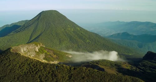Cinematic Aerial of Layered Mountains with Soft Fog at Sunset Indonesia