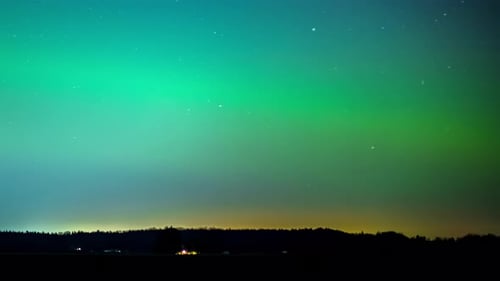 Green Aurora Borealis in night sky, time lapse view