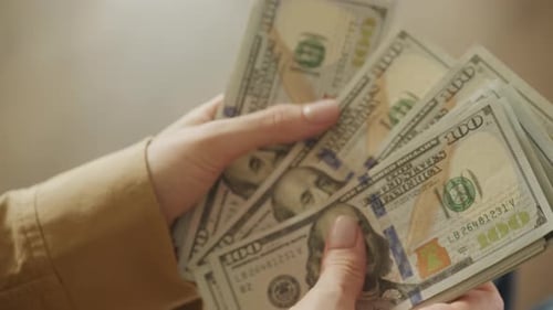 Counting Stack of One Hundred Dollar Bills