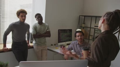 Female Programmer Making Presentation for Team in Office