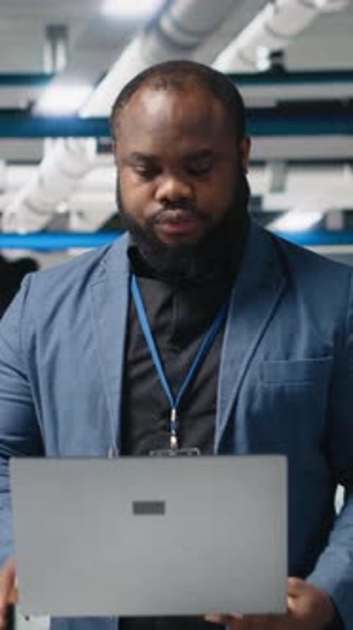 Vertical Video Black Solar Panel Engineer in a High Tech Facility Doing an Inspection