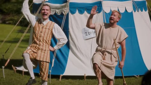 Actors In Medieval Attire Gesturing Together