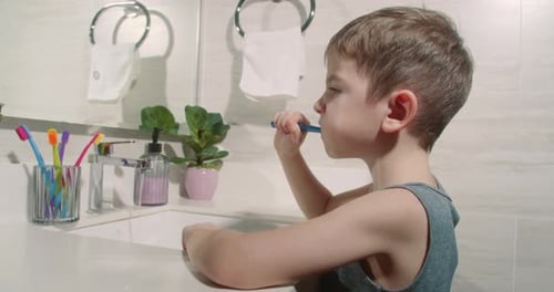 Baby Daily Healthcare Routine Caucasian Kid Brushing Looking at Mirror at Home Lifestyle Portrait