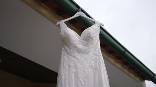 Elegant White Wedding Dress Hanging Outdoors