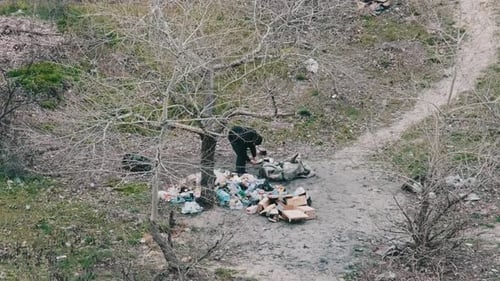 Figures Scavenging in Urban Wasteland