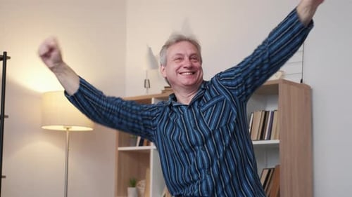 Happy Man Dancing in Pajamas Indoors
