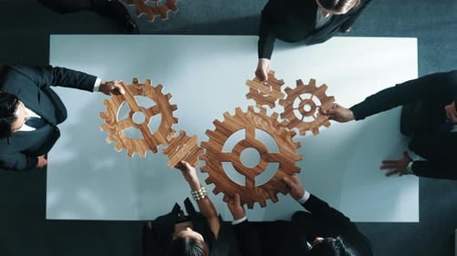 Top view of business team bring filled last cog to complete system. Directorate.