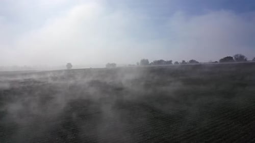 Fog Rolling Across Plowed Rural Field From Above