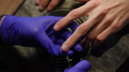 High Angle View Closeup Manicurist Cutting Male Nails in Slow Motion with Tool Closeup