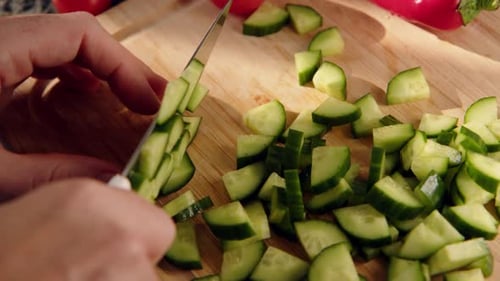Top Down View Female Hands Cut Green Fresh Cucumber on Board Closeup