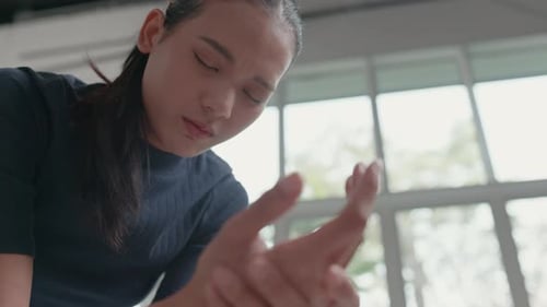 Young Woman Holding Her Wrist in Pain