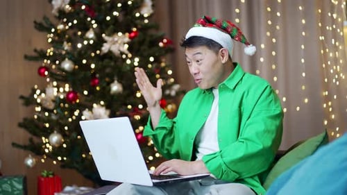 Man with Laptop Celebrates Christmas