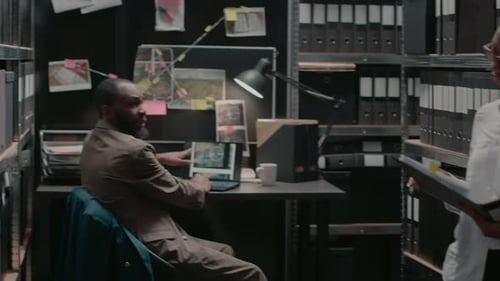 Woman Reads Files in a Dim Office Setting