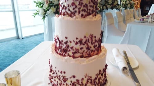 Elegant Wedding Cake with Floral Decorations and Table Settings