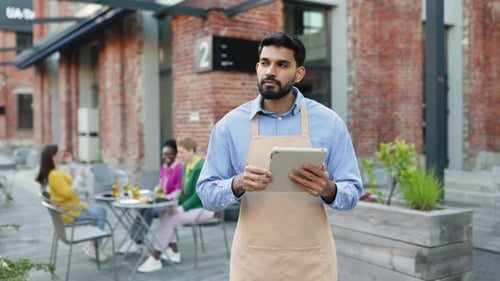 Waiter Taking Order at Outdoor Restaurant