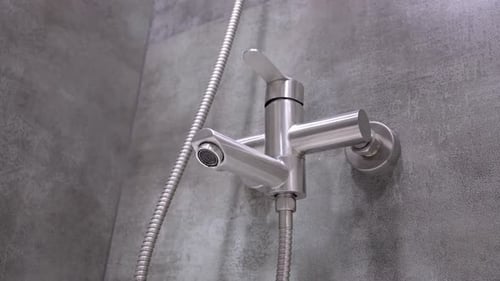 Dripping water faucet close up: plumbing issues and water conservation