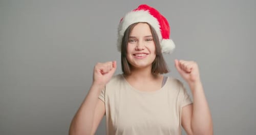 Excited Woman in Santa Hat Cheering