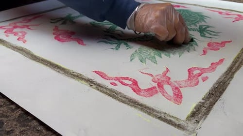 Frottage street art: Rubbing dragon drain cover with charcoal on paper