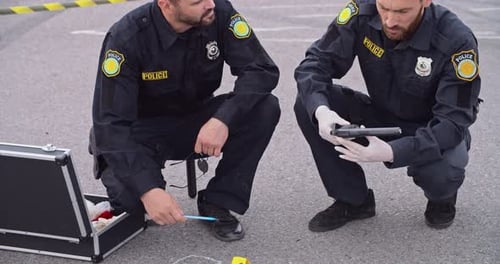 Police Officers Investigating Crime Scene with Chalk Outline