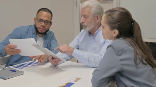 Business People Discussing Project on Digital Tablet in Office