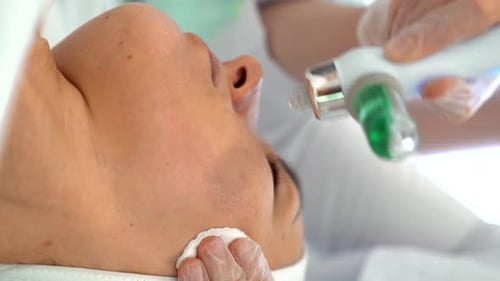 Adult Woman Receives Facial Cosmetic Treatment