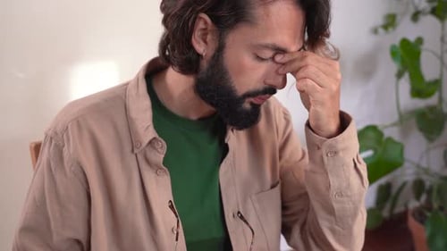 Man with Beard Using Laptop at Home