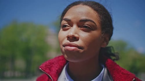 Young Woman Gazing into Sunlight Outside