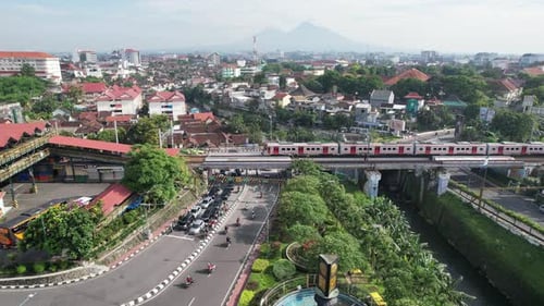 Aerial View of City with Train and Traffic