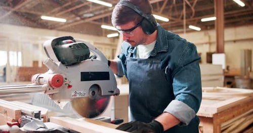 Wood, saw and man with machine in workshop for project in carpentry, process or cutting plank
