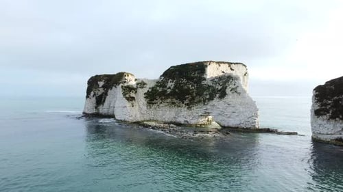 Close up drone shot flying towards Old Harry Rocks in Dorset, England