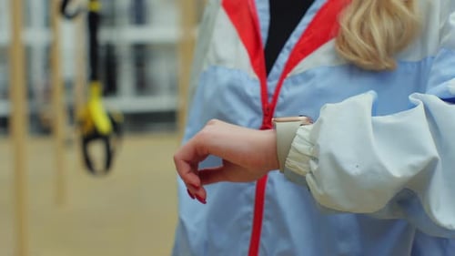 Close Up of Young Woman in the Sport Ground Check Health Indicator and Heart Rate on Smartwatch