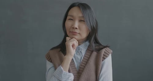 Slow Motion Portrait of Young Asian Woman Thinking Then Raising Finger Having Brilliant Idea