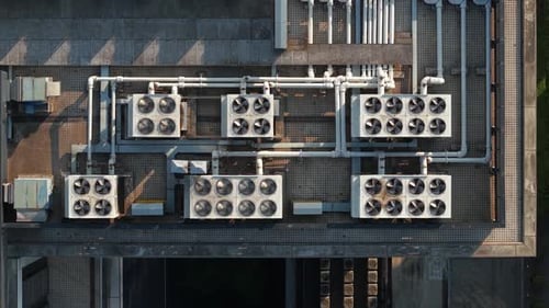 Aerial View of Multiple Cooling Units Situated on a Rooftop The System Features a Series of Large