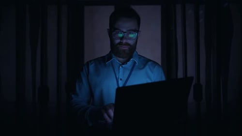 IT Professional Working on Laptop in Data Center