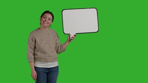 Front View of Confident Model Holding Blank Speech Bubble on Camera
