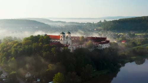 Aerial drone view of Benedictine Abbey over Vistula river in Tyniec in the morning fog, Krakow, Pola